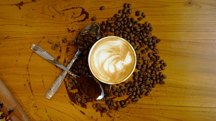 Coffee Latte with coffee beans scattered on the table