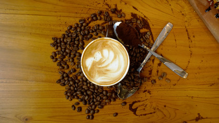 Coffee Latte with coffee beans scattered on the table