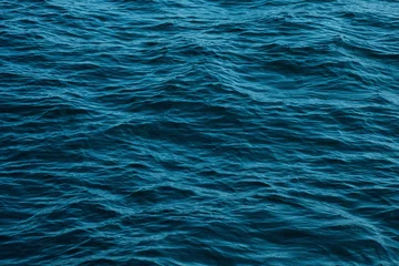 Gordijnen ocean wave high angle view blue water background © Alex
