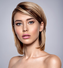 Fototapeta premium Close-up portrait of sexy caucasian young woman with beautiful blue eyes.