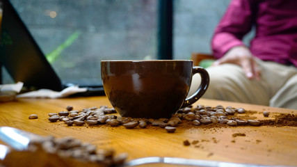 Coffee Latte with coffee beans scattered on the table