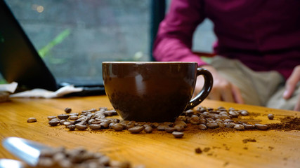Coffee Latte with coffee beans scattered on the table