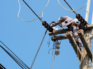 electrician man working at height and dangerous ,high voltage power line maintenance