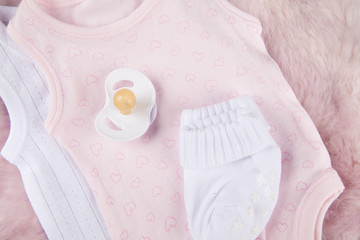 Baby outfit pink and white socks, pacifier 