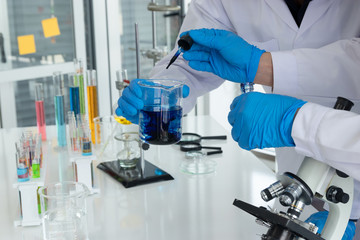 Fototapeta premium Scientists or doctors are testing bloods to prevent and destroy new strains of the virus through tube and beaker. Researching and experimenting for effective chemicals.
