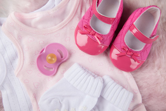 baby girl shoes and pacifier 