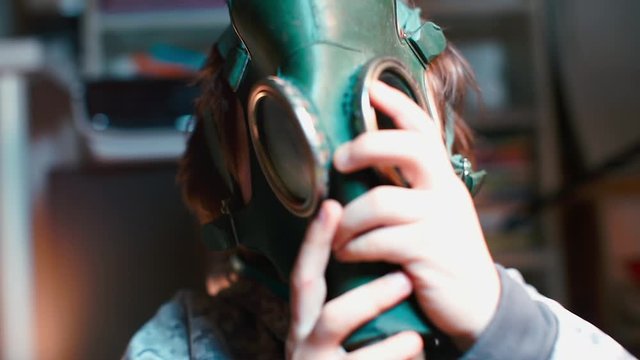 Close-up of putting a gas mask on a child head during quarantine.