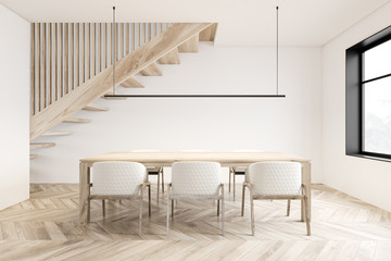 White dining room interior with stairs