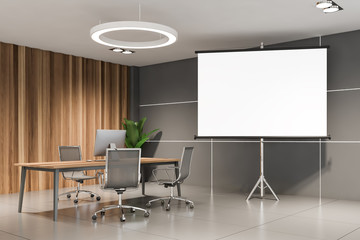 Gray and wooden CEO office with poster