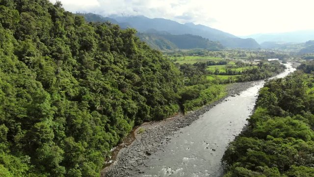 Rising high above Rio Quijos, a tributary of the Amazon in Ecuador, view upstream looking towards the Andes