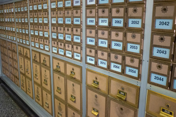 Rows of vintage post boxes of assorted sizes