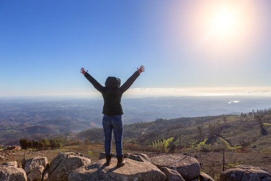 Girl woman reached the peak of the peak, admires the success, and the sun. Monchique, Foia, Portugal.