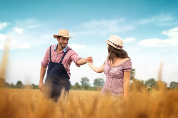 Affectionate couple having fun in field wheat