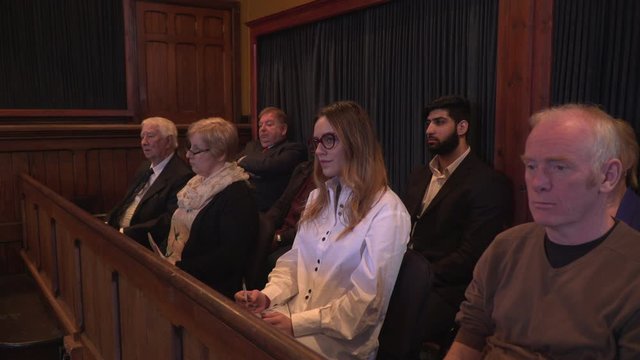 Jury sat in Courtroom during court case. They are listening to the facts from the legal proceedings. and look unimpressed