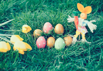Tulips and decorated eggs on grass