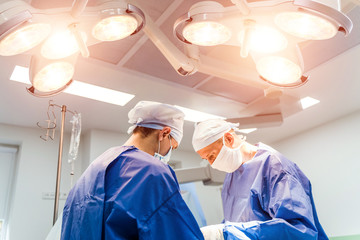 Team surgeon at work in operating room. Modern equipment in operating room. Medical devices for...