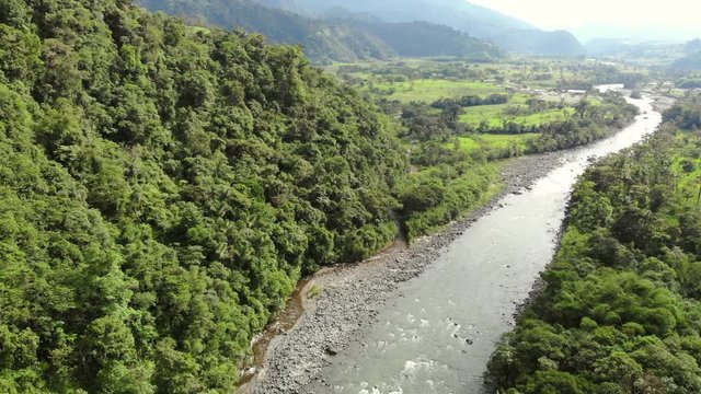 Aerial tilt down to Rio Quijos, a tributary of the Amazon in Ecuador, view upstream looking towards the Andes