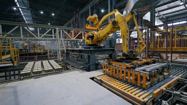 Robotic arm is relocating fresh bricks in fast motion