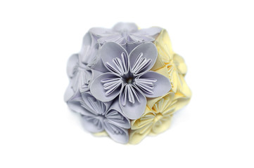 Purple and yellow origami kusudama flower on white background
