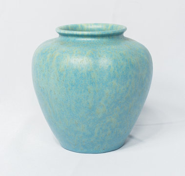 A vintage antique ceramic fragile pottery royal lancastrian 1916 blue and aqua vase isolated on a white background. old pottery pots from the past, found in junk shops and thrift stores.