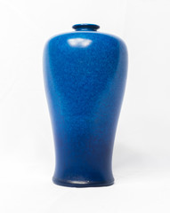 A vintage antique ceramic fragile pottery royal lancastrian 1916 blue vase isolated on a white background. old pottery pots and objects from the past, found in junk shops and thrift stores.