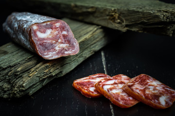 Farm smoked sausage on a dark background