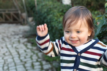 One year old baby smiling outdoors