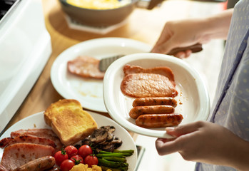 Female cooking breakfast on kitchen counter bar.Healthy food,simple eating