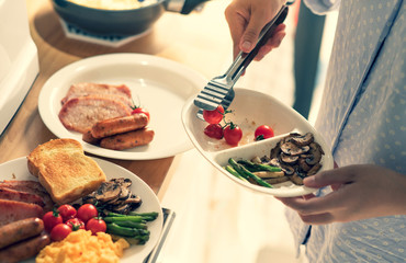 Female cooking breakfast on kitchen counter bar.Healthy food,simple eating