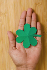 Happy Saint Patrick's mockup of  shamrock clover leaves on wooden board 