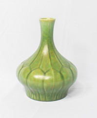 A vintage antique ceramic fragile pottery royal lancastrian 1916 green vase isolated on a white background. old pottery pots from the past, found in junk shops and thrift stores.