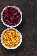 Top view of red beans and peas In a plate on a dark background with space for text