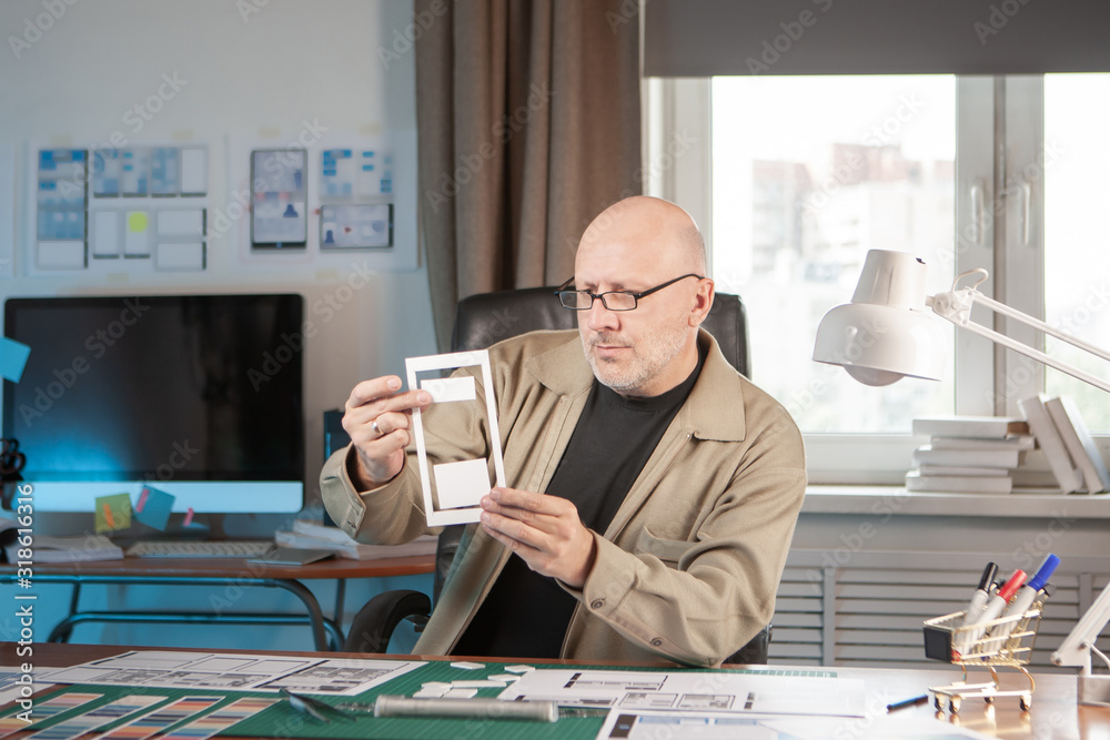 Poster interface designer. device preview.the process of developing the design of mobile applications.a man