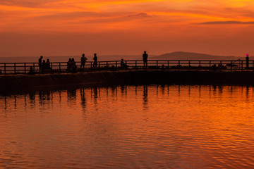 Fototapeta na wymiar Sunset in Lake Nglanggeran / Embung Nglanggeran, a lake that holds rainwater at a height, Gunungkidul, Yogyakarta.