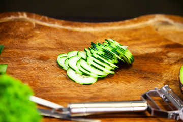Wooden cutting board with courgette slices
