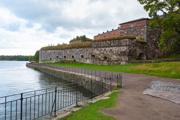 Finland. Helsinki. Suomenlinna. Sveaborg. Ancient stone fortress on the Baltic sea. The road along the walls of the fortress. Streets of Sveaborg fortress on a cloudy day. Excursions in Suomenlinna.