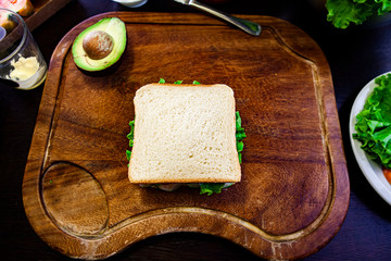 Toast stuffed on cutting board and avocado. flat lay