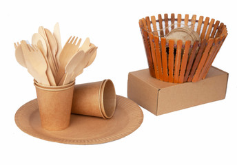 Crockery made from eco kraft paper, paper cups, dishes, bag, fast food containers isolated on white background. Recycling concept. Zero waste. Close-up...