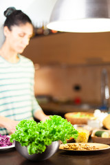 Girl prepares a healthy vegetarian recipe in a modern kitchen