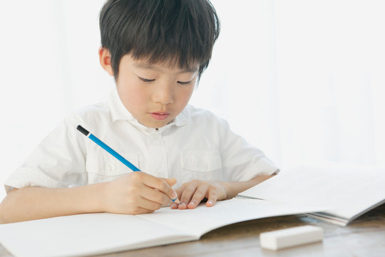 Boy writing in notebook