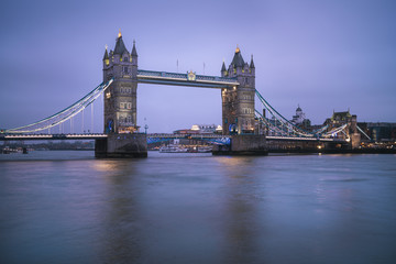 Perspective view of illuminated Tower Bridge during blue hour — London, United Kingdom