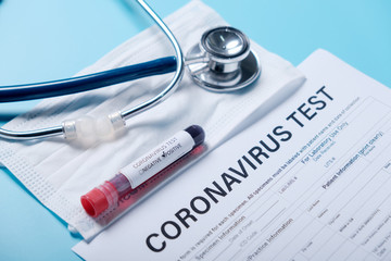 2019-nCoV  in Wuhan, China. virus Coronavirus blood test in Laboratory Coronavirus test list medical form, mask,test blood tubes stethoscope on blue copy space background