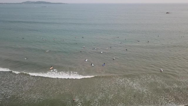 Aerial view of the Weligama bay and many surfers at sunrise. Sri Lanka aerial view