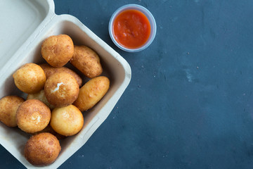 Fried Risotto Arancini stuffed with cheese, served with tomato sauce