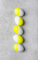 Five eggs on a gray concrete background