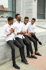 Fototapeta premium four handsome young african men in white shirts