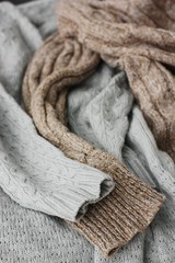 Fototapeta na wymiar Beautiful knitted grey and brown sweaters macro
