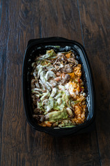 Take Away Mexican Food Carne Asada Steak Fillets, Guacamole Sauce, Pinto Beans and Rice in Plastic Container Box / Package.