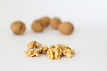 Peeled walnut closeup. Golden walnut kernel on a white background. Healthy foods.