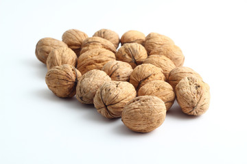 Peeled walnut closeup. Golden walnut kernel on a white background. Healthy foods.